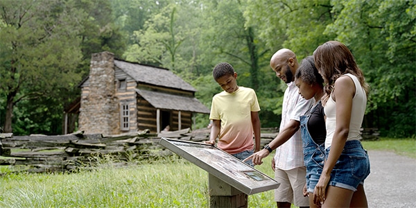 Family visiting historic sites in Cades Cove